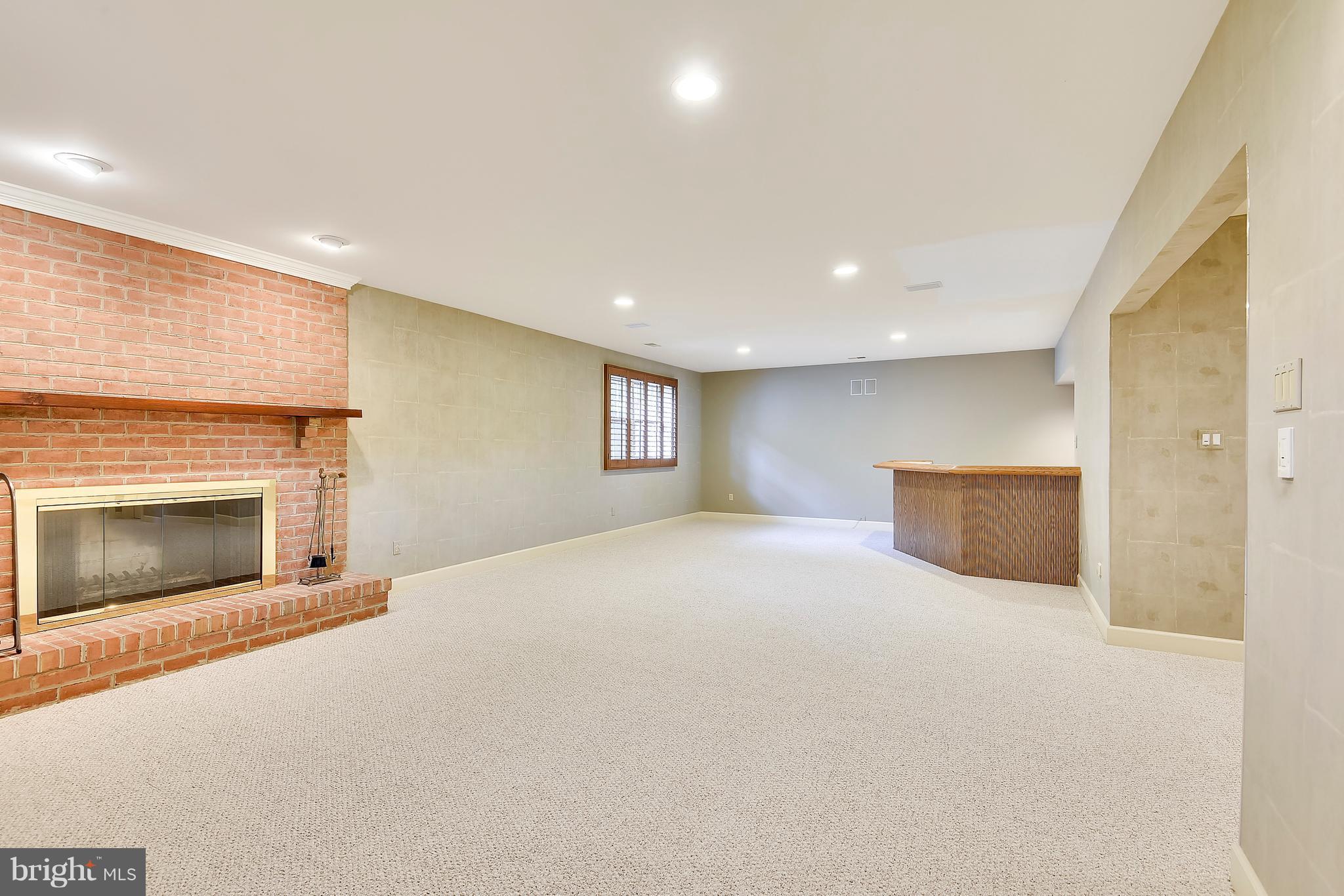 1823 Solitaire Lane McLean, VA 22101 - Photo 20 of 30 Sunny LL rec room with built-ins and fireplace.