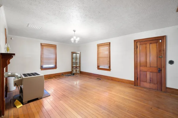 a kitchen with a table chairs refrigerator and microwave