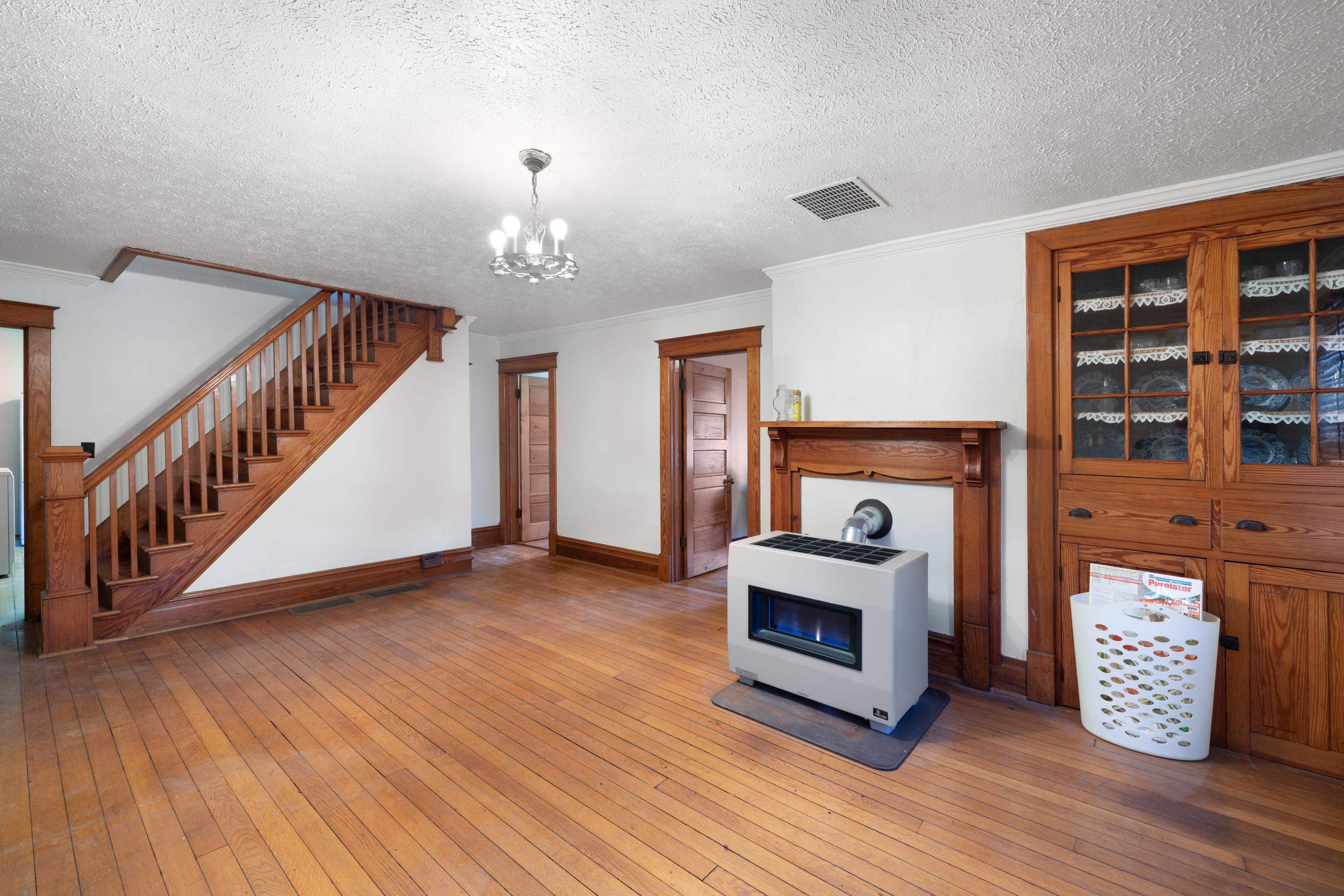 3165 Old Greenville Road Staunton, VA 24401 - Photo 15 of 66 a view of an empty room with wooden floor fireplace and windows