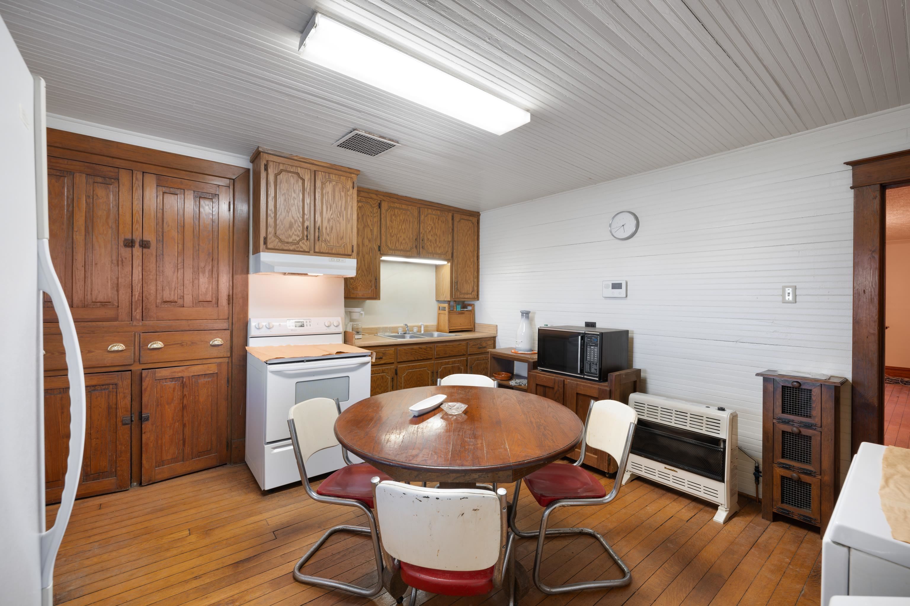 3165 Old Greenville Road Staunton, VA 24401 - Photo 19 of 66 a kitchen with a table chairs refrigerator and microwave