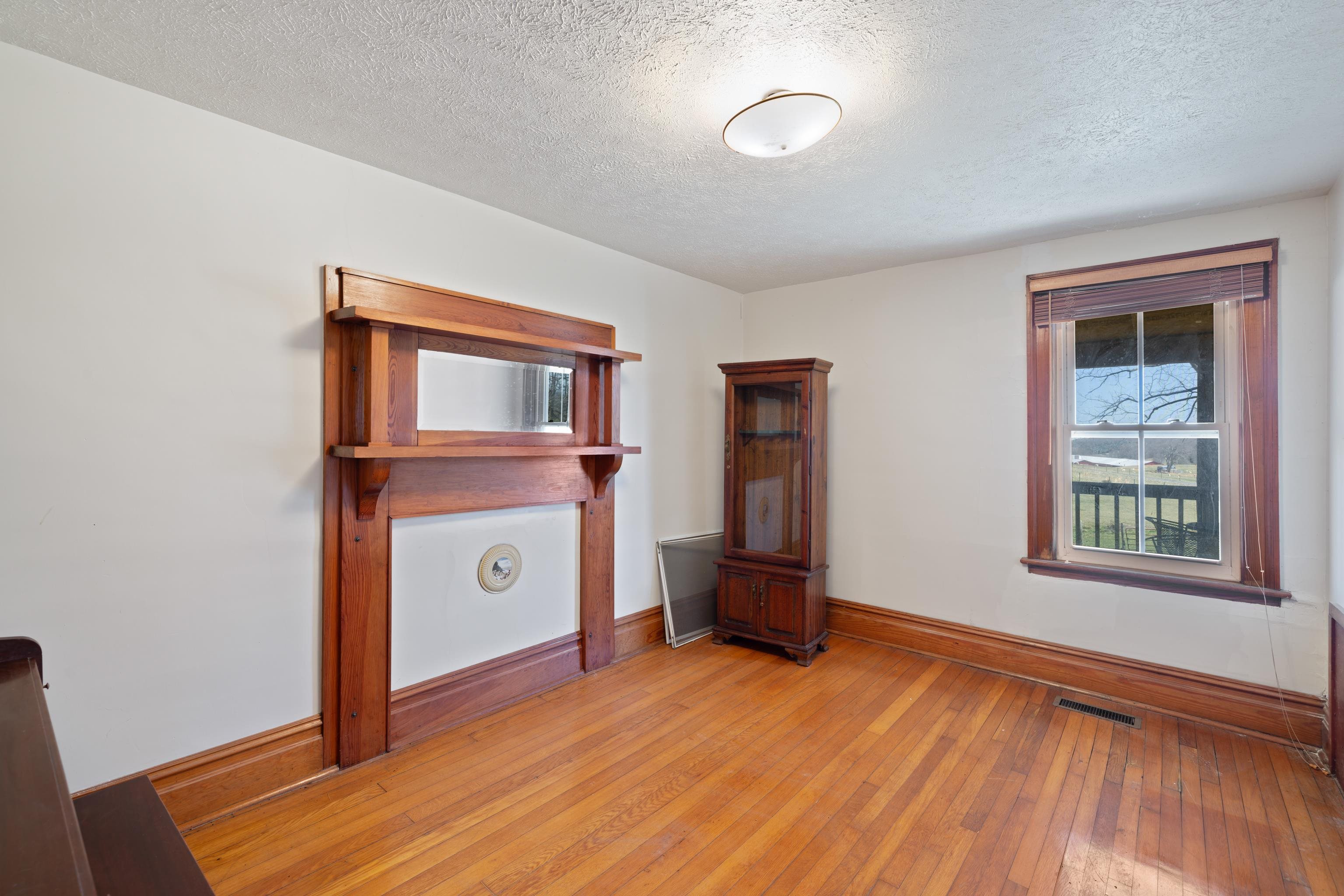 3165 Old Greenville Road Staunton, VA 24401 - Photo 23 of 66 a view of an empty room with window and wooden floor