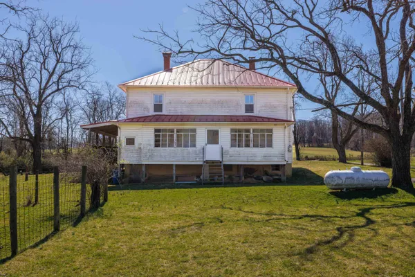 a view of a house with a yard and sitting area