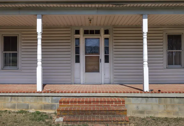 a view of an entryway with wooden floor and door