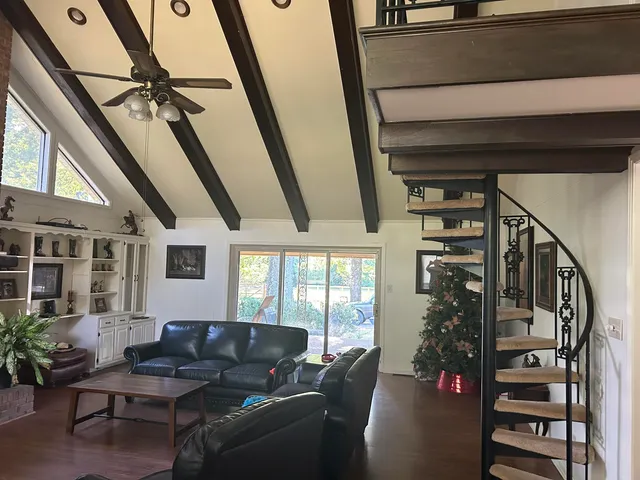 a living room with furniture and a floor to ceiling window