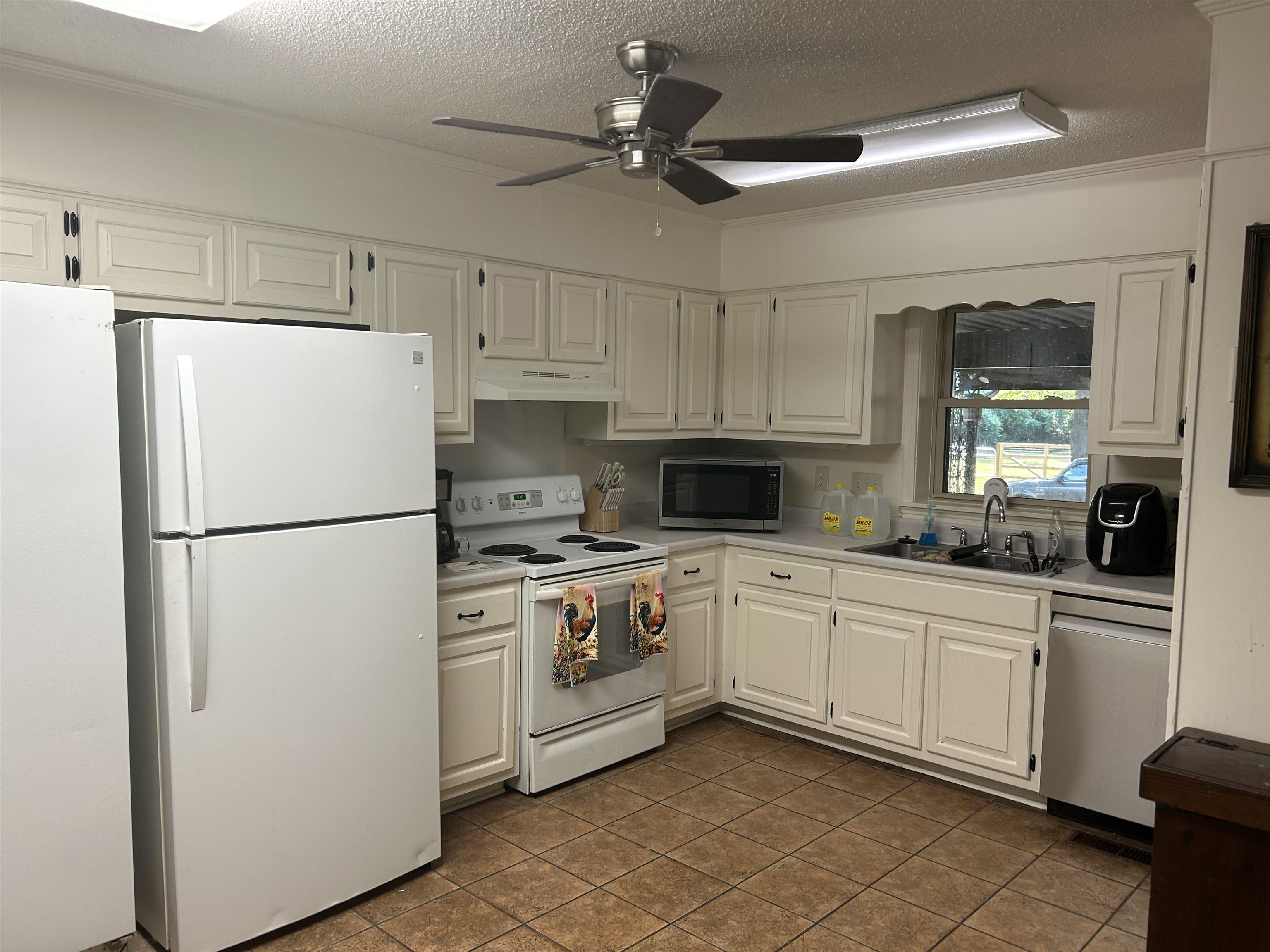 2051 Solo Road Covington, TN 38019 - Photo 12 of 31 a kitchen with white cabinets and white stainless steel appliances