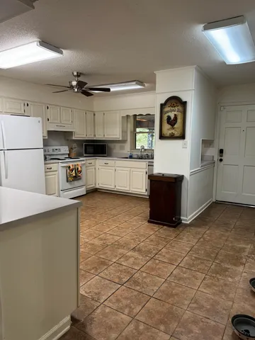 a kitchen with stainless steel appliances a refrigerator and a stove top oven