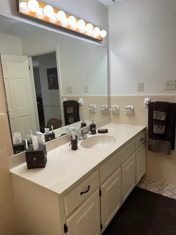 a bathroom with a sink double vanity and a mirror