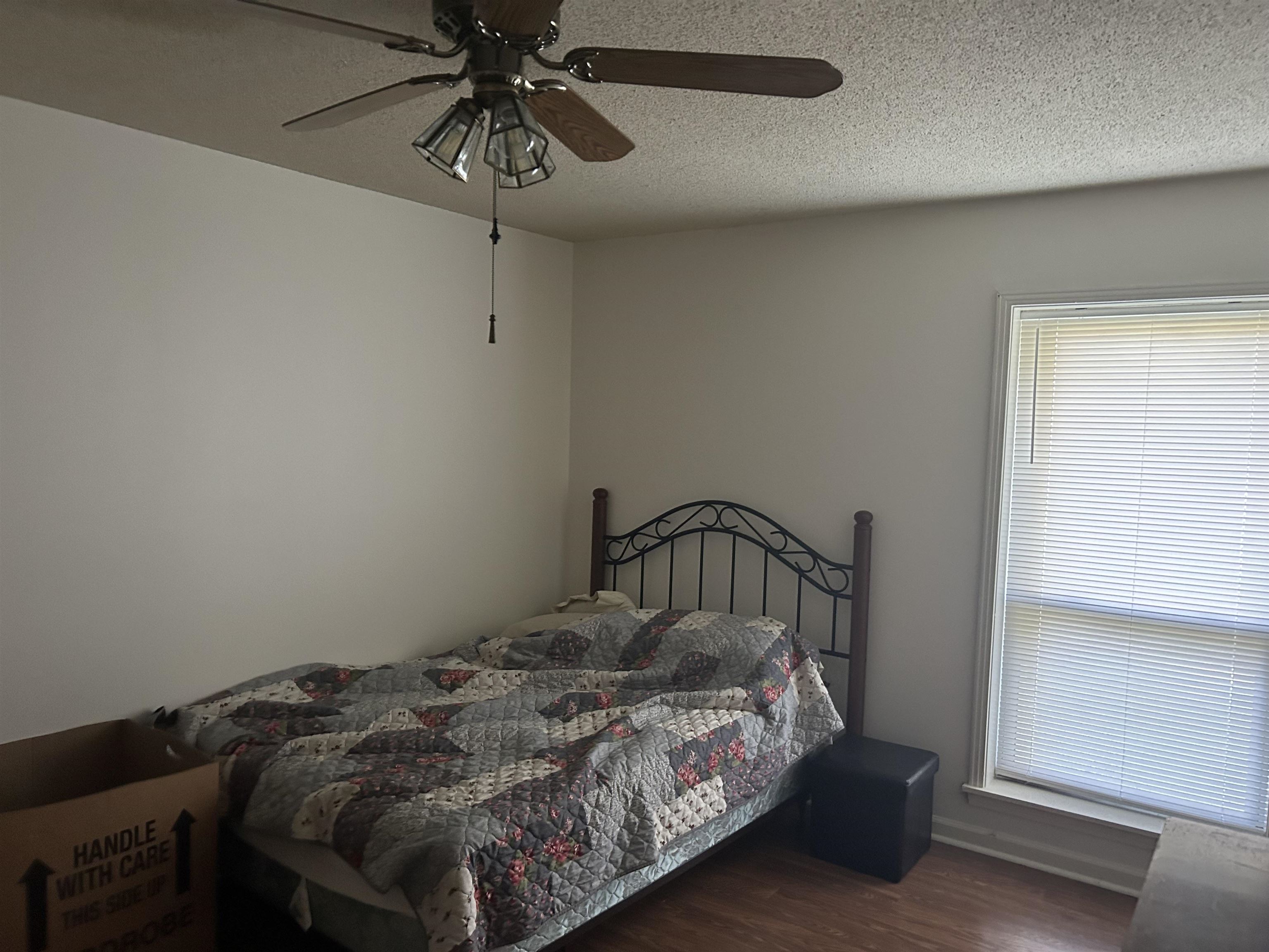 2051 Solo Road Covington, TN 38019 - Photo 6 of 31 a bedroom with a bed and a chandelier