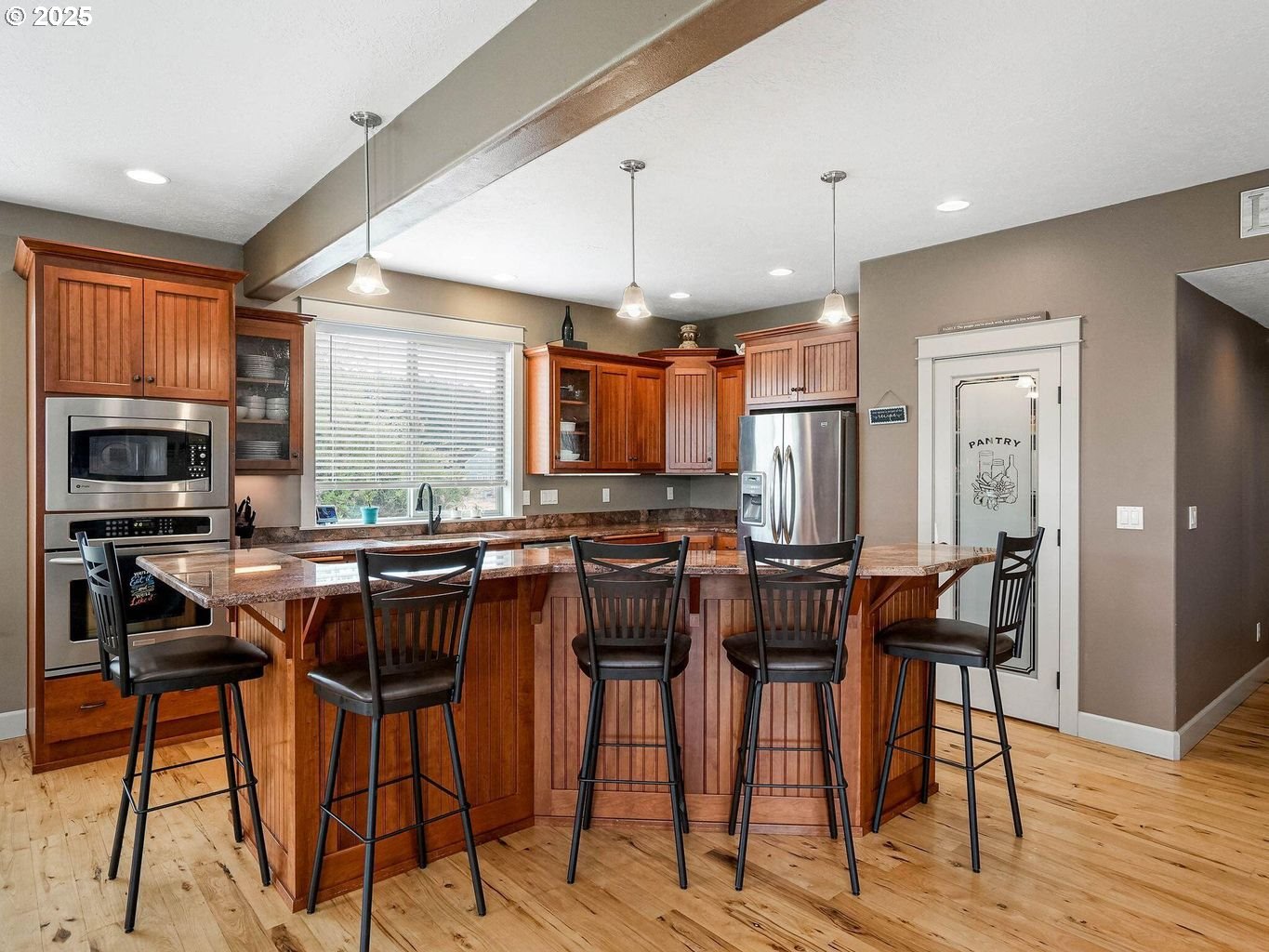 40893 Elk Ridge Lane Stayton, OR 97383 - Photo 9 of 46 a kitchen with stainless steel appliances kitchen island granite countertop a table chairs stove and a sink