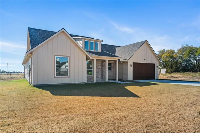a view of a house with pool and yard