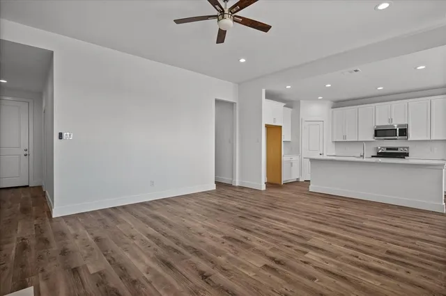 a view of a kitchen with a sink and a refrigerator