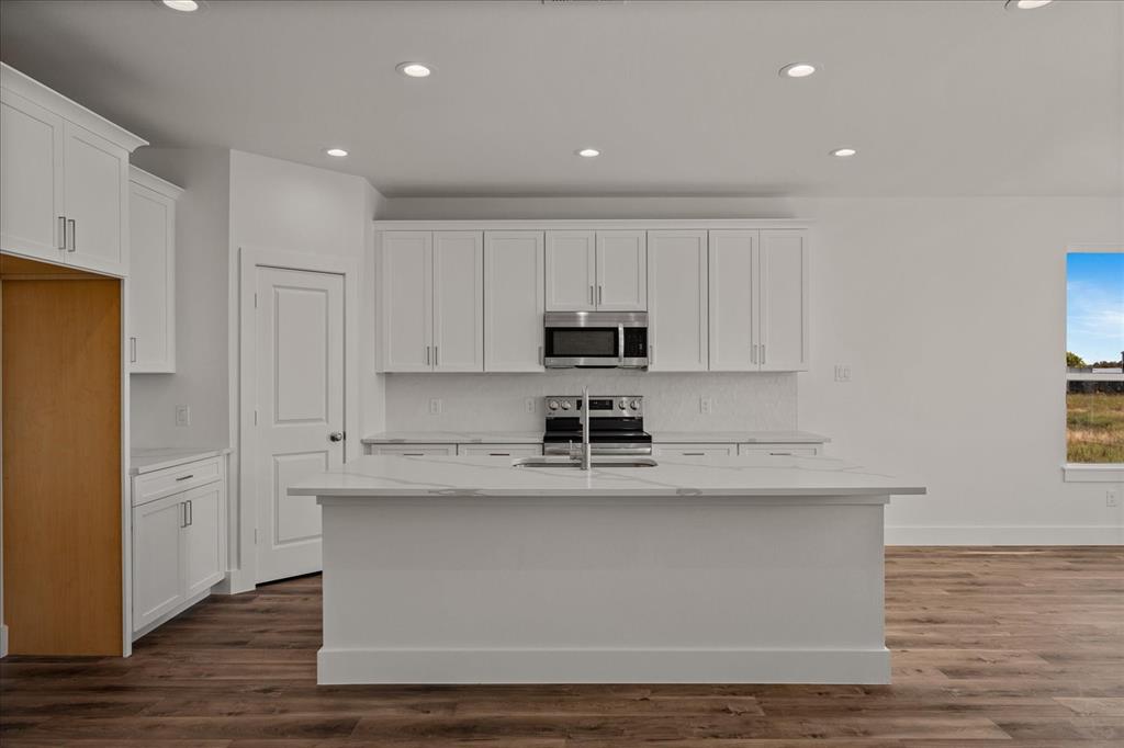 3250 Willow Road Celeste, TX 75423 - Photo 9 of 32 a view of kitchen with stainless steel appliances granite countertop cabinets and wooden floor