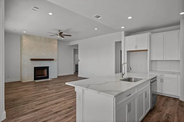 a kitchen with a sink appliances and cabinets
