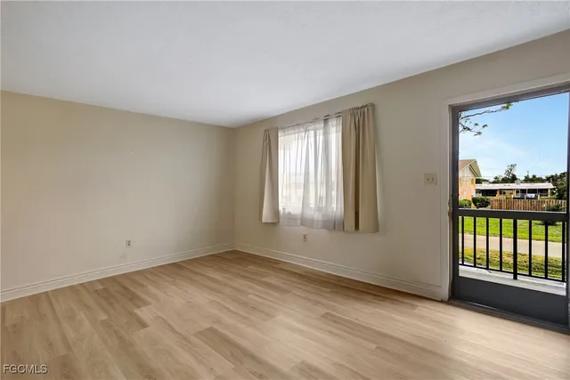 a view of a kitchen with a sink and a refrigerator
