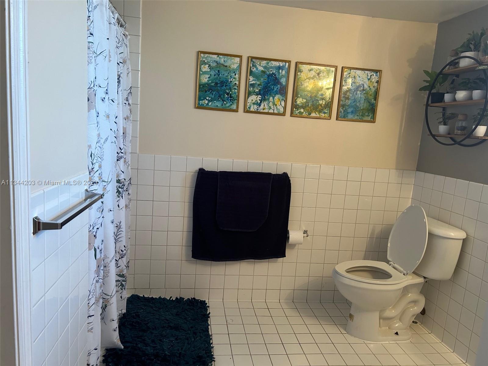 55 East 4th Street, Unit 302 Hialeah, FL 33010 - Photo 11 of 17 a bathroom with a toilet and a shower