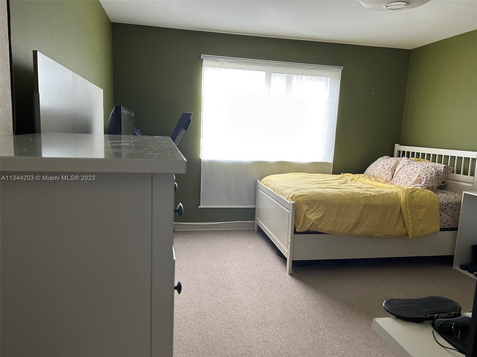 55 East 4th Street, Unit 302 Hialeah, FL 33010 - Photo 12 of 17 a bedroom with a bed and large window