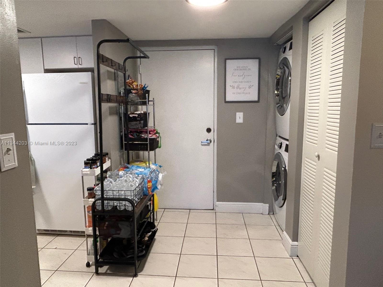 55 East 4th Street, Unit 302 Hialeah, FL 33010 - Photo 7 of 17 a view of kitchen with furniture and refrigerator