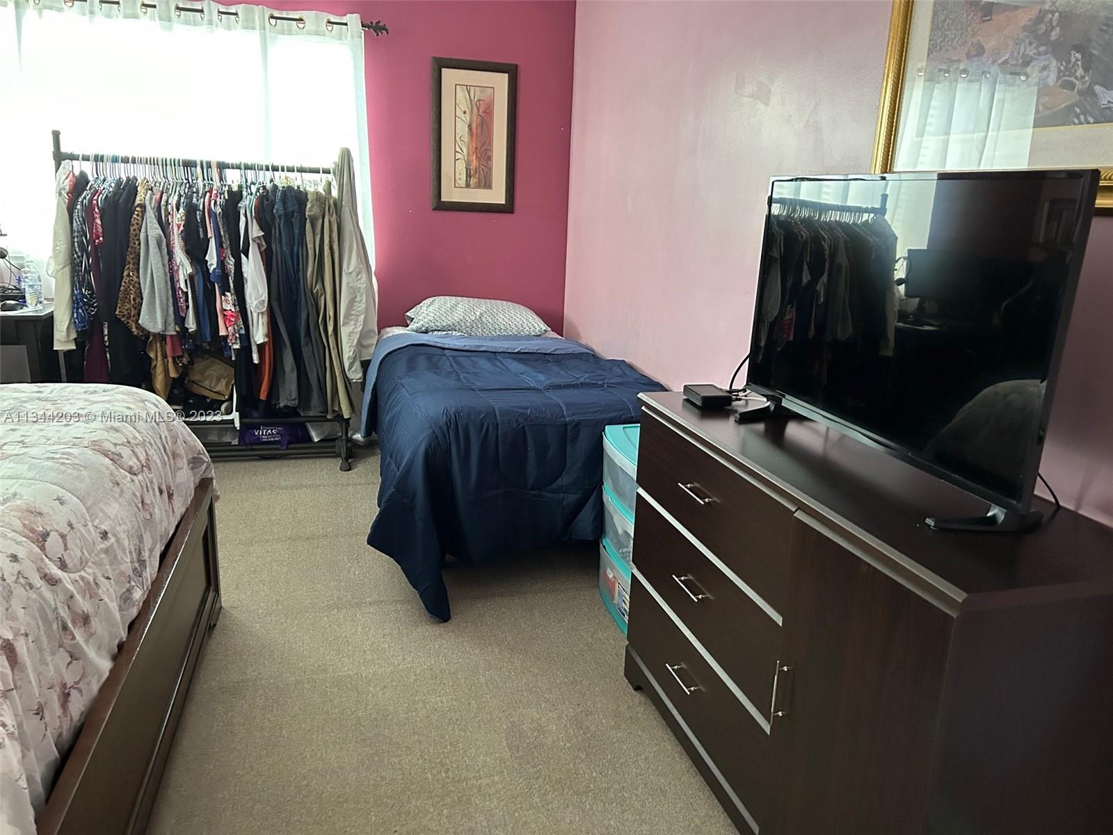 55 East 4th Street, Unit 302 Hialeah, FL 33010 - Photo 9 of 17 a bed room with a bed and a television