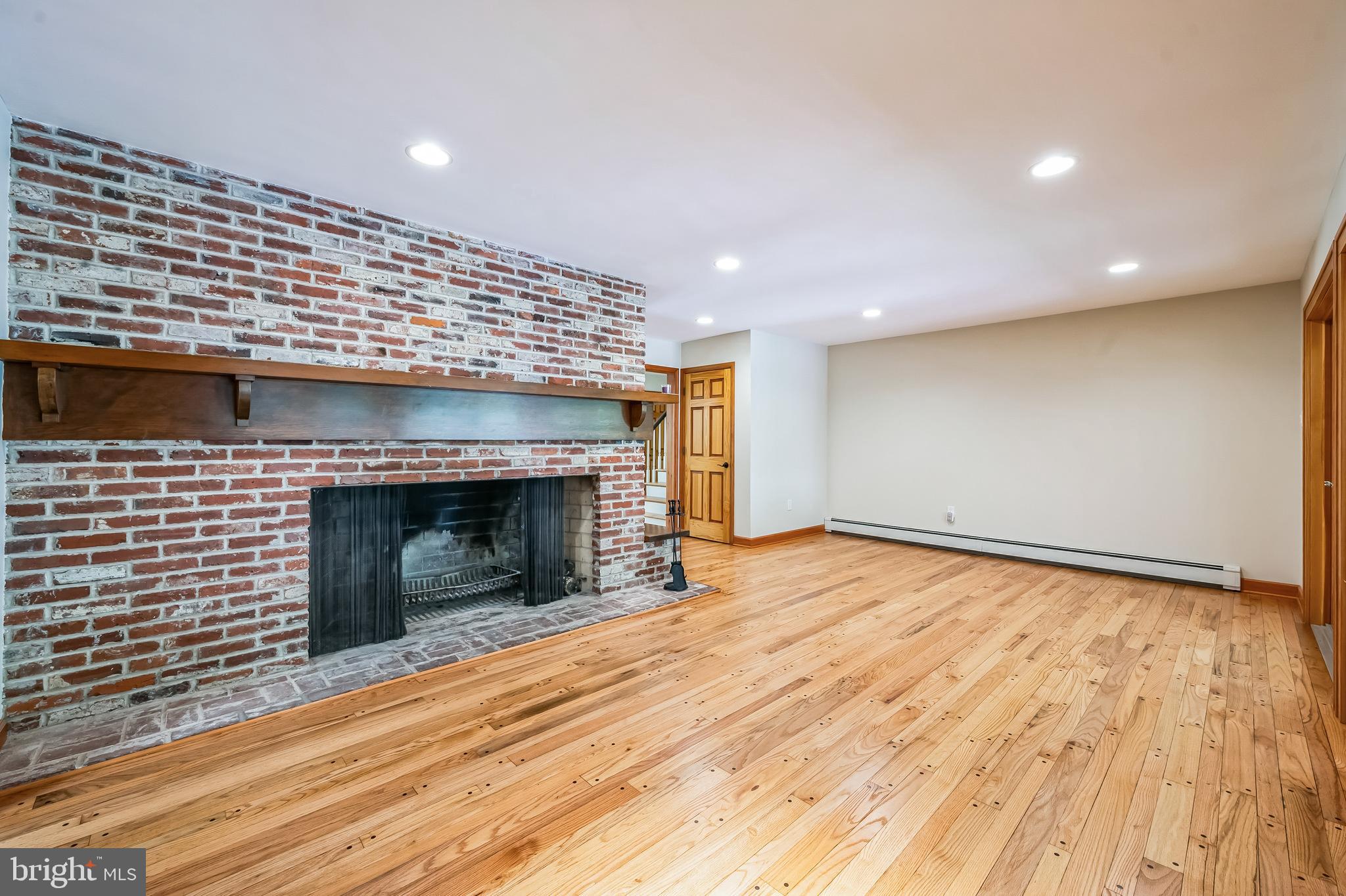 3574 Glenway Road Huntingdon Valley, PA 19006 - Photo 14 of 60 a view of an empty room with wooden floor fireplace and a window