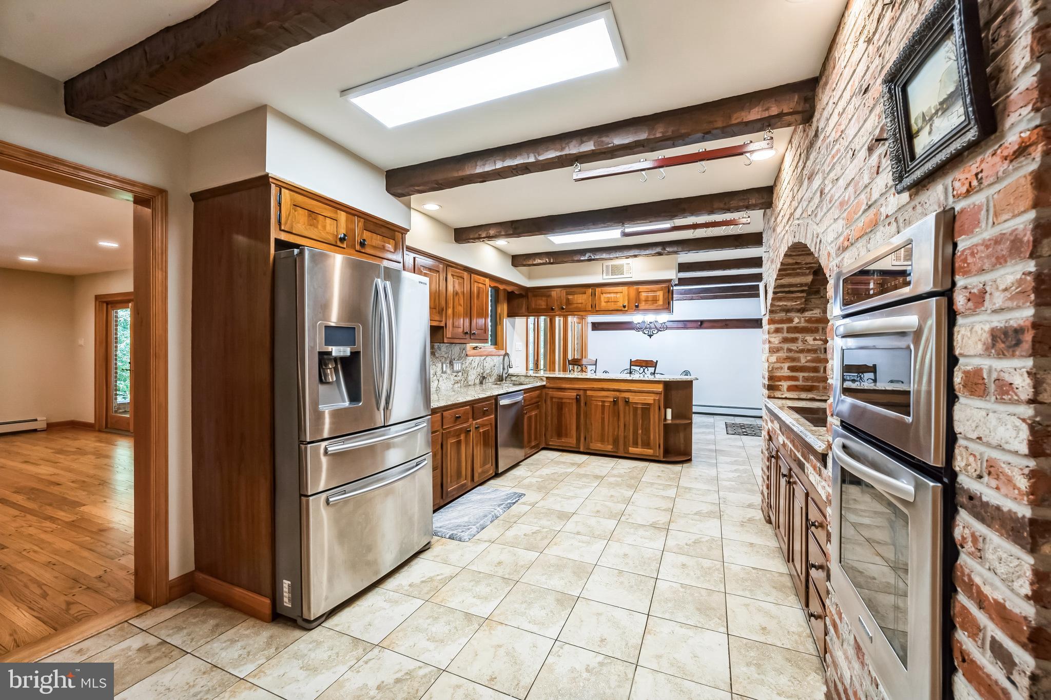 3574 Glenway Road Huntingdon Valley, PA 19006 - Photo 23 of 60 a kitchen with stainless steel appliances granite countertop a refrigerator and a stove top oven