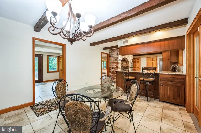 a spacious bathroom with a double vanity sink a toilet a mirror and a shower