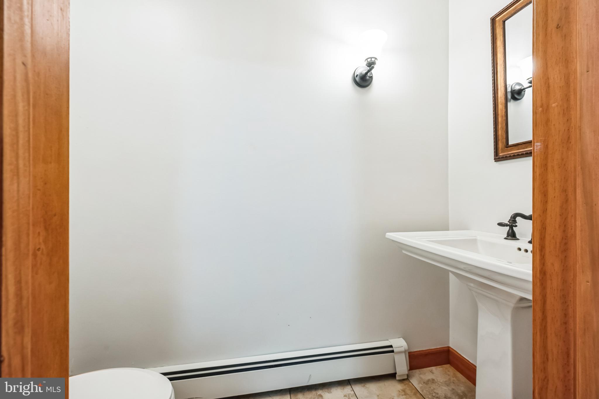 3574 Glenway Road Huntingdon Valley, PA 19006 - Photo 30 of 60 a bathroom with a sink a toilet and mirror