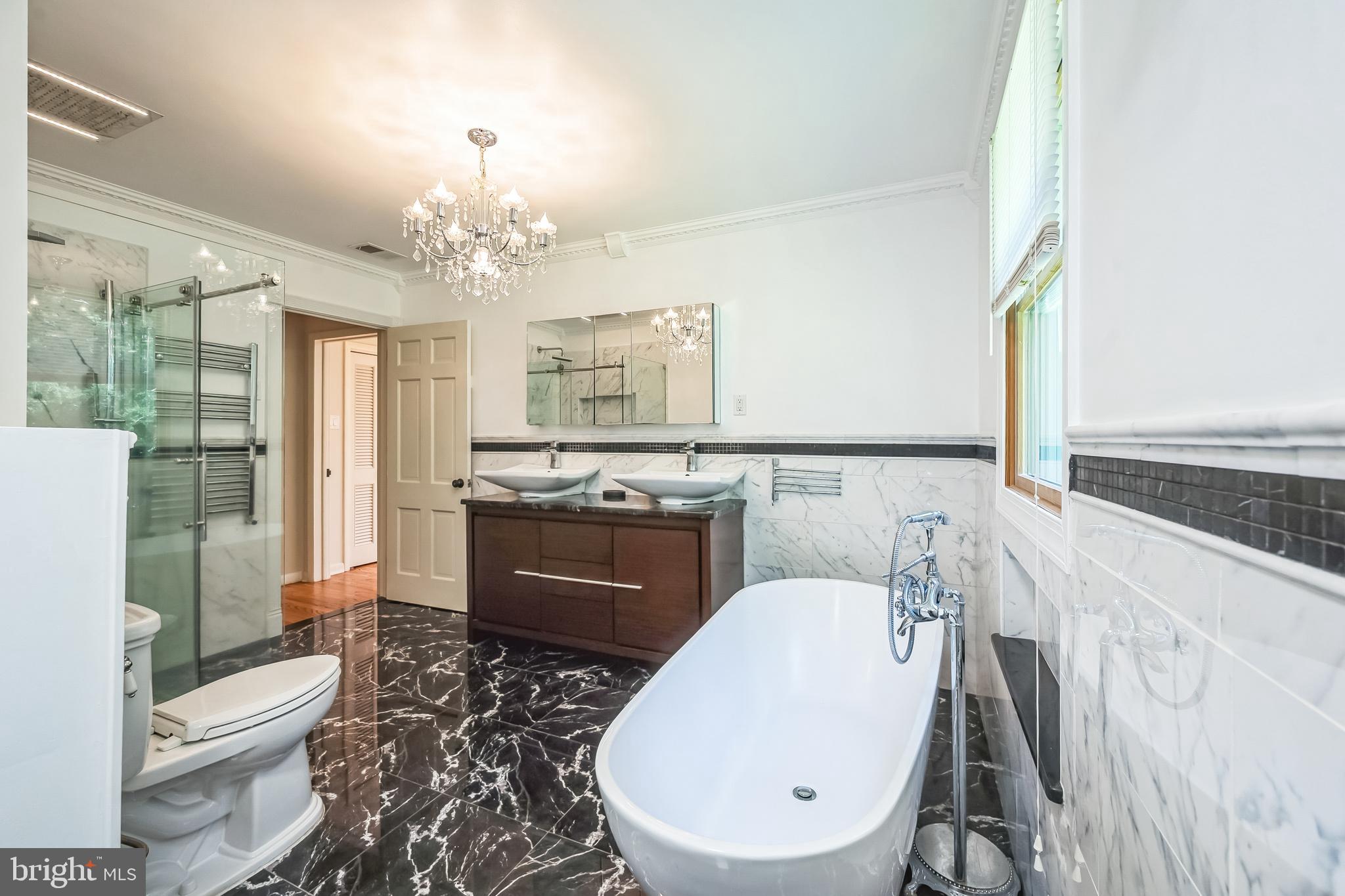 3574 Glenway Road Huntingdon Valley, PA 19006 - Photo 32 of 60 a spacious bathroom with a double vanity sink a toilet a mirror and a shower