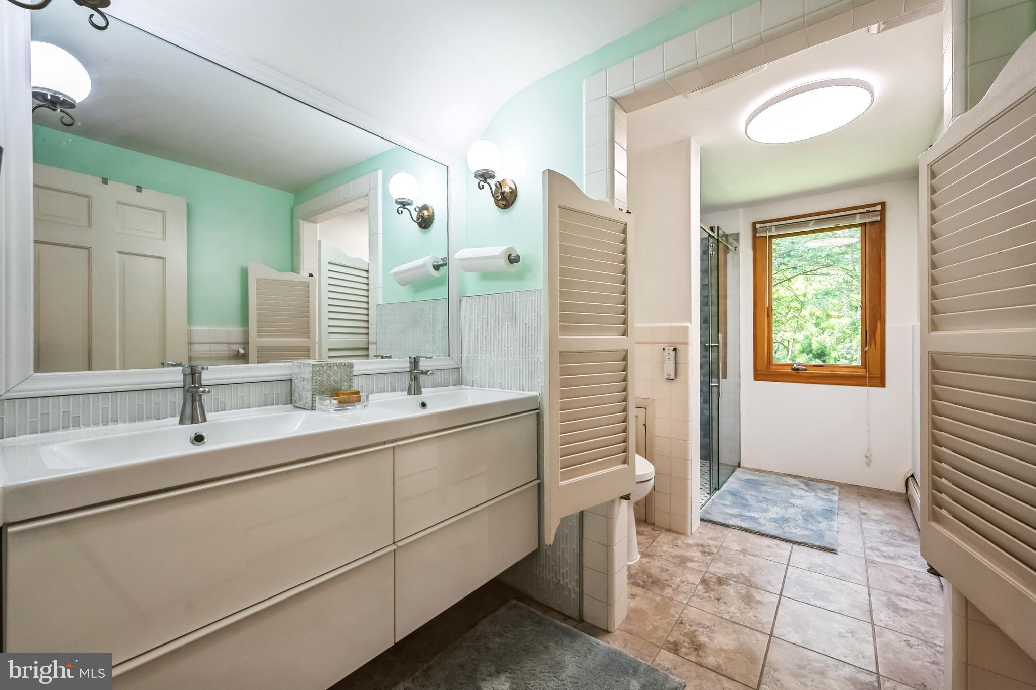 3574 Glenway Road Huntingdon Valley, PA 19006 - Photo 33 of 60 a bathroom with a double vanity sink a toilet and a shower