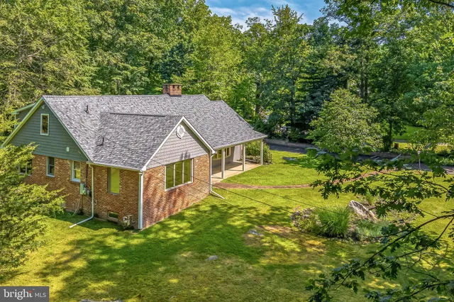 an aerial view of a house with a yard table and chairs