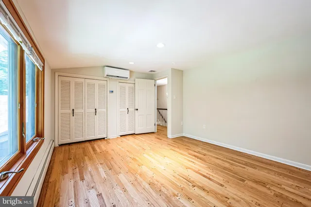 a front view of house with yard and trees in the background