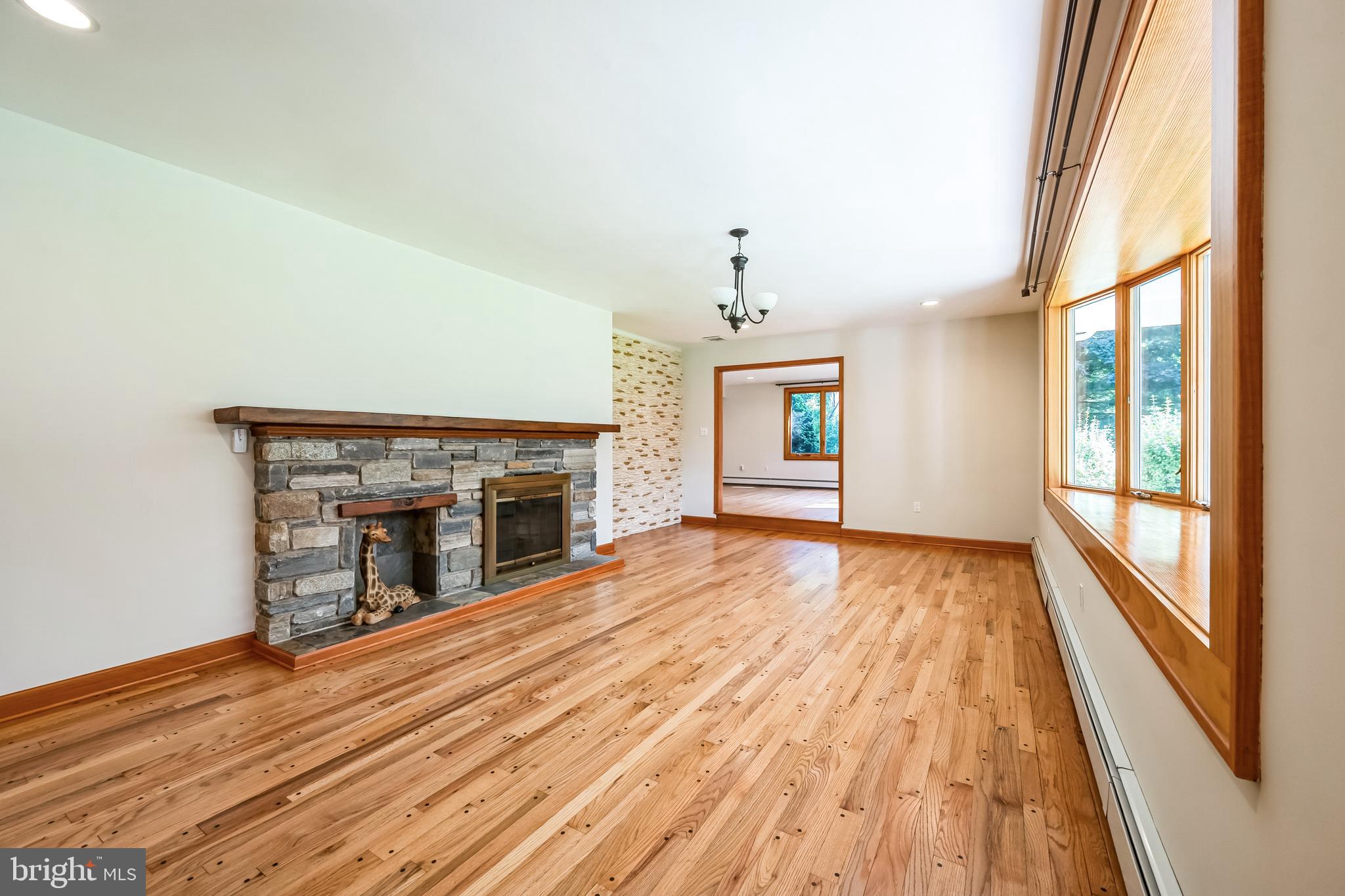 3574 Glenway Road Huntingdon Valley, PA 19006 - Photo 9 of 60 a view of an empty room with wooden floor fireplace and a window