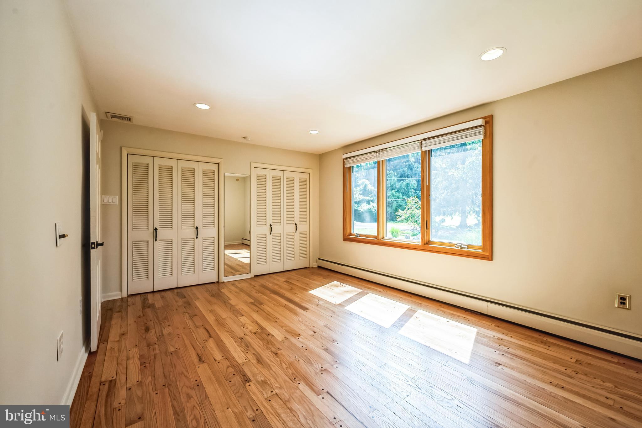 3574 Glenway Road Huntingdon Valley, PA 19006 - Photo 10 of 60 a view of an empty room with wooden floor and a window