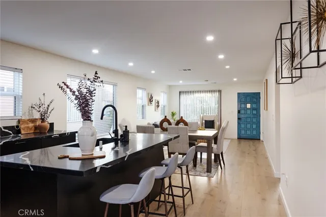 a view of a dining room with furniture and chandelier