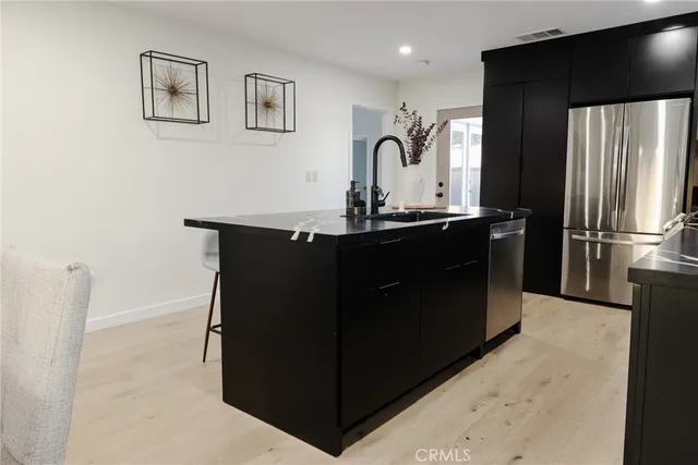 a bedroom with a bed and a wall painting