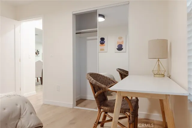 a bedroom with a bed and a potted plant