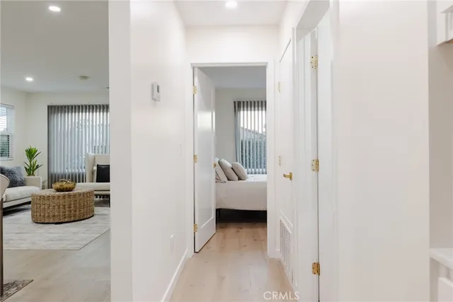 a bedroom with a bed and a potted plant