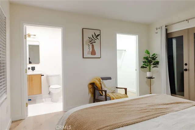 a white toilet sitting next to a white sink
