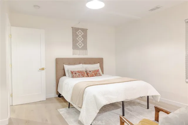 a view of a patio with table and chairs with wooden floor and fence