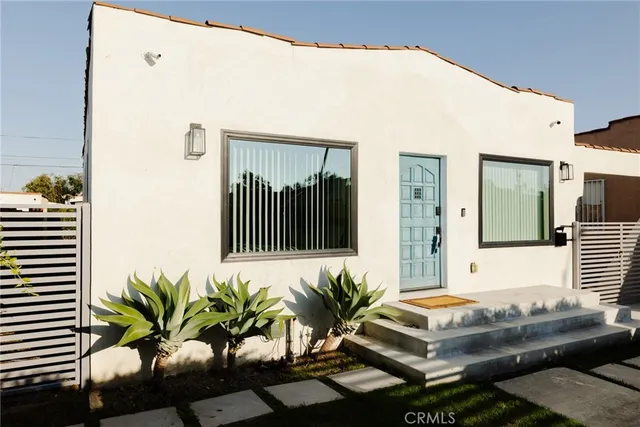 a living room with furniture and view of wooden floor