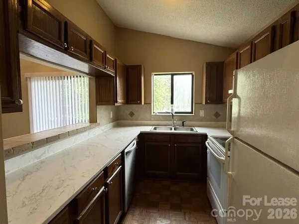 a kitchen with a sink a stove and cabinets