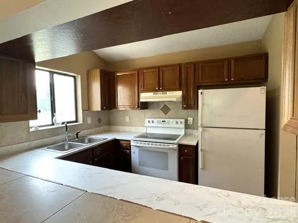 a kitchen with a sink a stove and refrigerator