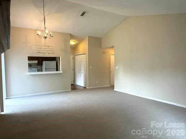 en empty room with a ceiling fan and a fireplace