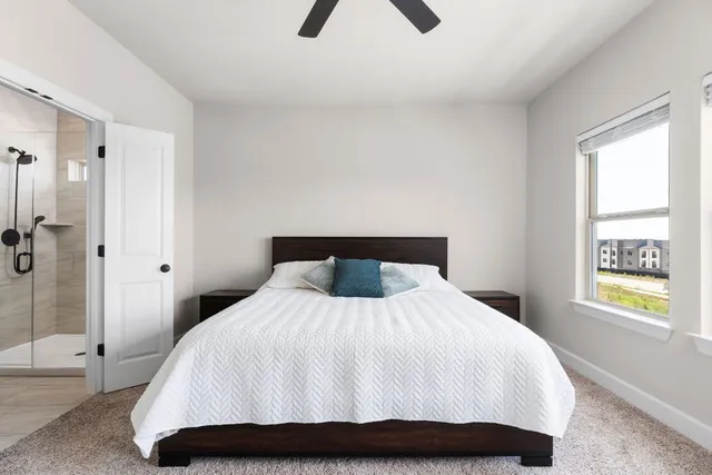 a bedroom with a bed and a window