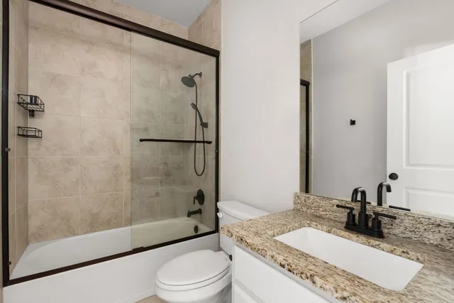 a view of house exterior with wooden floor and fence