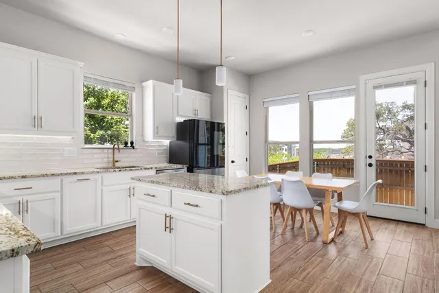 a very nice looking living room with a large window and wooden floor