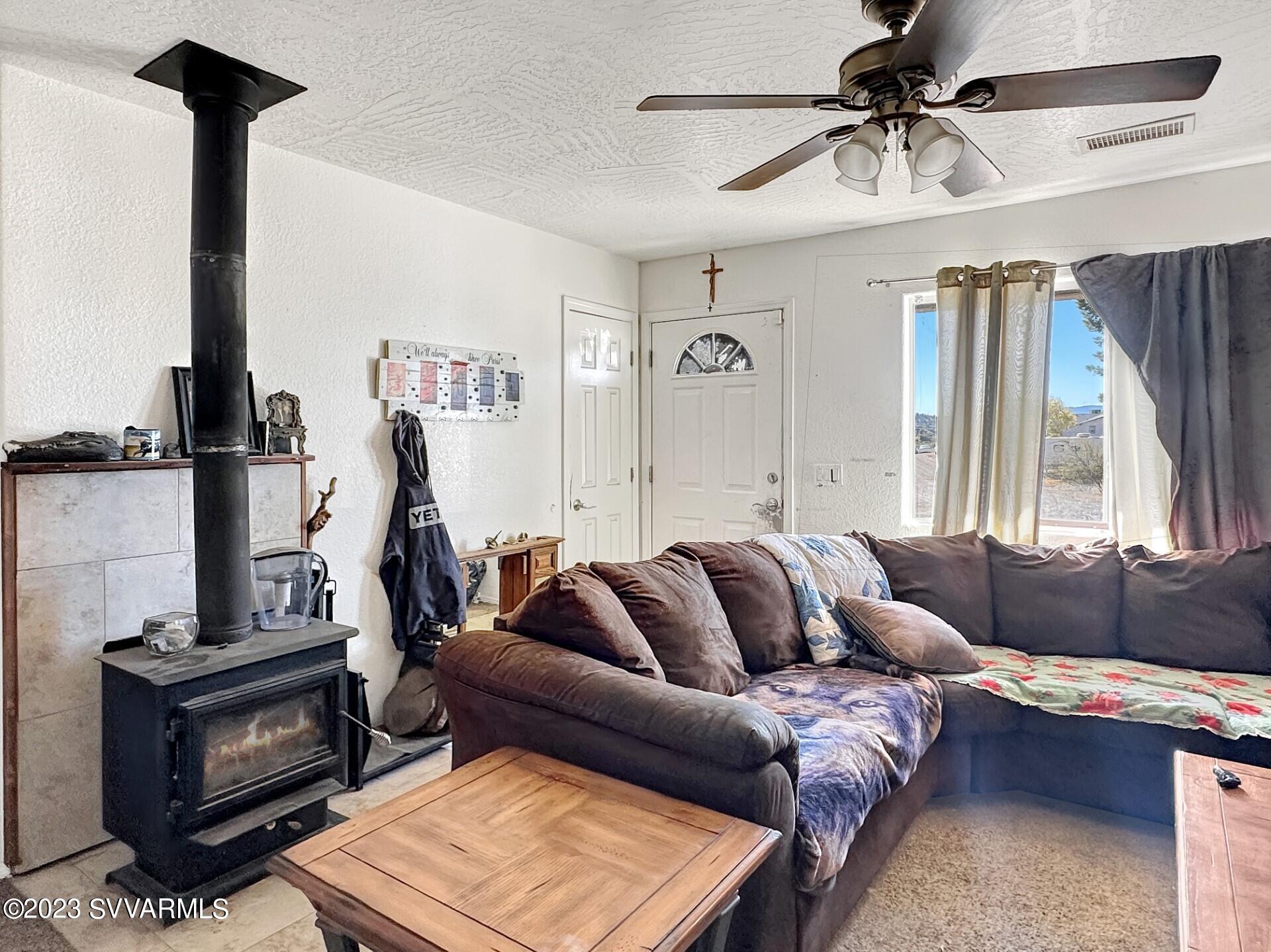 4510 East Steven Rimrock, AZ 86335 - Photo 3 of 9 a living room with furniture and a fireplace