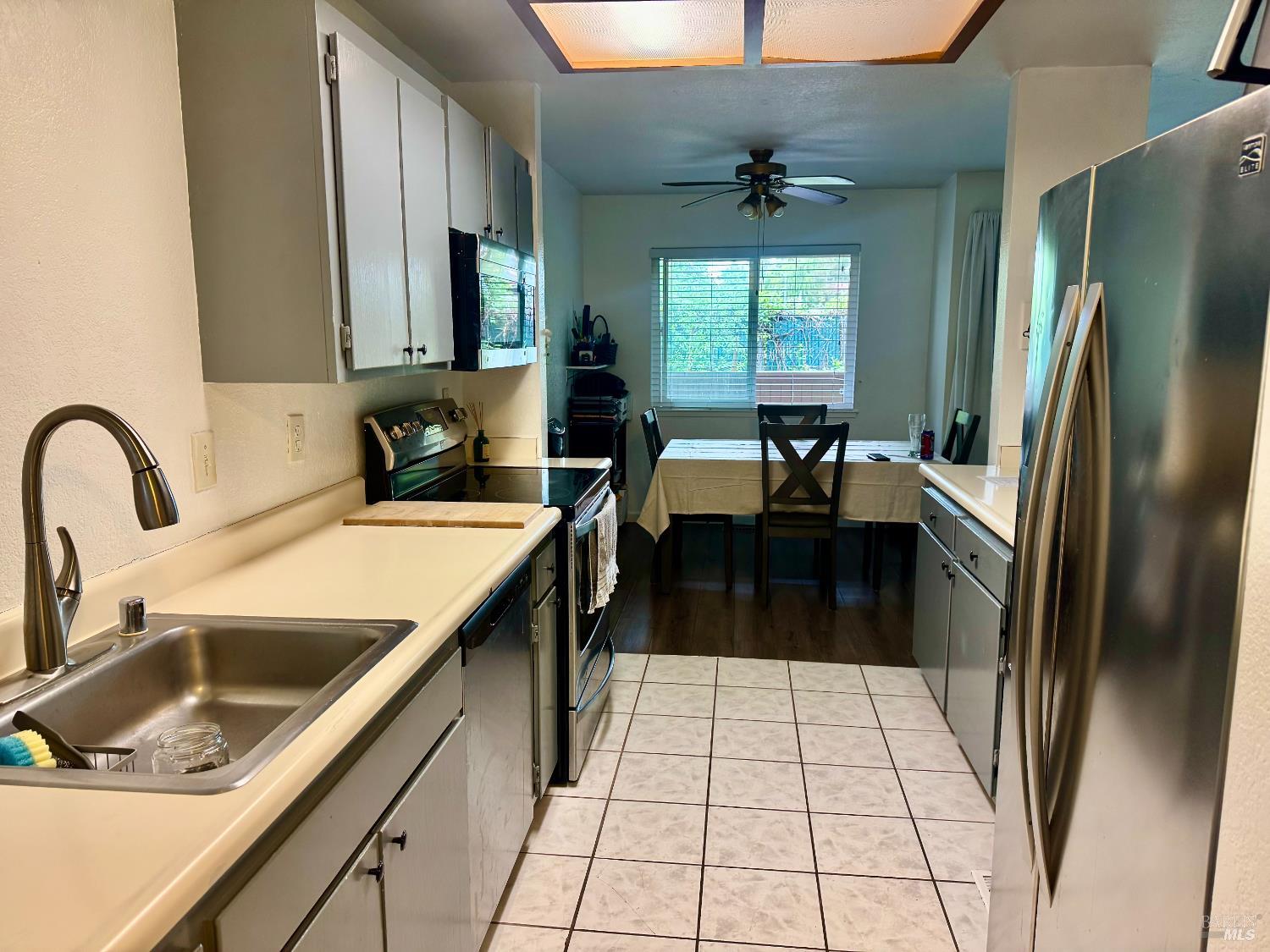 2528 Westberry Drive Santa Rosa, CA 95403 - Photo 21 of 37 a kitchen with a sink a refrigerator and a stove top oven