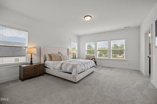 a bedroom with a large bed and a flat screen tv