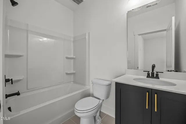 a bedroom with a bed and painting on the wall