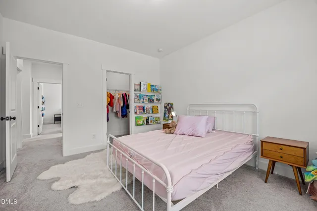 a bathroom with a double vanity sink toilet and a mirror